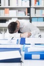 Exhausted businessman sleeping on his desk Royalty Free Stock Photo