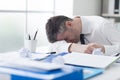 Exhausted businessman sleeping on his desk Royalty Free Stock Photo