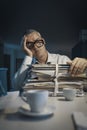 Exhausted businessman working overtime in the office Royalty Free Stock Photo