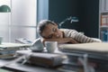 Exhausted businesswoman sleeping on her desk Royalty Free Stock Photo