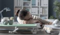 Exhausted businesswoman sleeping on her desk Royalty Free Stock Photo