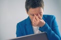 Exhausted businesswoman working overtime on office laptop computer