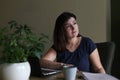 Exhausted, calm, stressed and unproductive brunette woman working in office with laptop. Frustration with terrible work Royalty Free Stock Photo