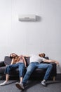 Exhausted couple suffering from heat while