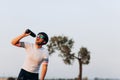 Exhausted cyclist in helmet drinking water Royalty Free Stock Photo