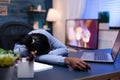 Exhausted dark skinned woman resting on office table