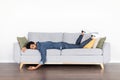 Exhausted eastern man sleeping on couch at home Royalty Free Stock Photo