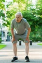 Exhausted elderly man after his jogging workout
