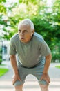 Exhausted elderly man after his jogging workout