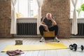 Exhausted elderly man resting after his fitness workout