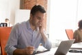 Exhausted employee suffer from dizziness working at laptop