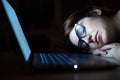 The exhausted employee worked overtime and fell asleep at his desk. Deadline Work at night with a laptop. The student is Royalty Free Stock Photo