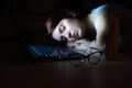 The exhausted employee worked overtime and fell asleep at his desk. Deadline Work at night with a laptop. The student is Royalty Free Stock Photo