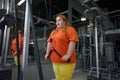 Exhausted excess overweight woman training with equipment at gym Royalty Free Stock Photo