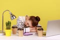 Exhausted fatigued woman office manager sleeping at workplace, lying surrounded by coffee cups.