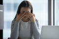 Exhausted female employee suffer from headache at workplace Royalty Free Stock Photo