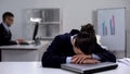 Exhausted female manager lying on laptop, tense working schedule, burnout
