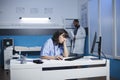 Exhausted female nurse in clinic office