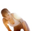 Exhausted female taking breath after running. Portrait of an exhausted young female resting after running on bright