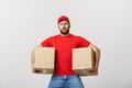 Exhausted handsome delivery man holding boxes and taking a break. on white Royalty Free Stock Photo