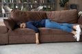 Exhausted Indian woman fall asleep on couch at home