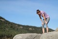 Exhausted jogger resting in the mountain