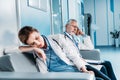 exhausted male and female doctors sleeping on sofa in hospital