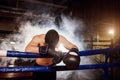 Exhausted man with bowed head down in ring