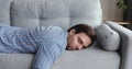 Exhausted man came home after work flopped down on sofa