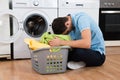 Exhausted Man With Laundry Basket Sitting By Washing Machine Royalty Free Stock Photo