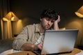 An exhausted man leans his head on his hand while sitting at the table and falling asleep, a tired man falls asleep