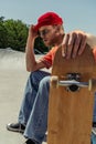 exhausted man sitting with blurred skateboard Royalty Free Stock Photo