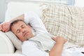 Exhausted man sleeping on the couch at home Royalty Free Stock Photo