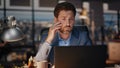 Exhausted man working laptop in late night office closeup. Tired businessman Royalty Free Stock Photo