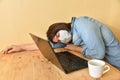 Exhausted masked woman fell asleep while working on laptop at home Royalty Free Stock Photo
