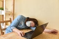 Exhausted masked woman fell asleep while working on laptop at home Royalty Free Stock Photo