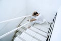 Exhausted medical worker sitting on stairs