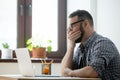 Tired sleepy manager in glasses yawning at work in office Royalty Free Stock Photo