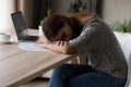 Tired woman fall asleep at desk working on computer