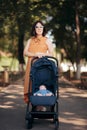 Tired Bored Mother Walking Newborn in Baby Stroller