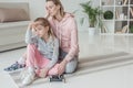 exhausted mother and daughter relaxing on yoga mat