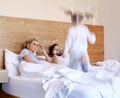 Exhausted parents struggling to put hyperactive toddler child to bed. Tired mom and dad annoyed about noisy active Royalty Free Stock Photo