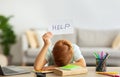 Exhausted schooler doing homework, showing help card