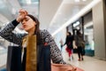 Exhausted shoppingholic woman in shopping mall.Buying in designer store.Wardrobe sale shopping.Hoby buyer.Weakness for clothes.