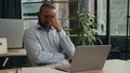 Exhausted sick mature senior businessman tired African American ethnic man office executive work on computer typing feel Royalty Free Stock Photo