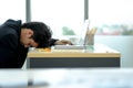 Exhausted sick tired male manager in office sad boring sitting with head down on laptop. Frustrated worker mental health problems