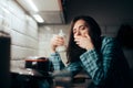 Tired Mother Holding a Milk Baby Bottle at Night Royalty Free Stock Photo