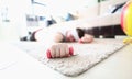 Exhausted Sportsman Lying on Floor with Dumbbells