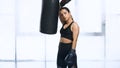 exhausted sportswoman in boxing gloves leaning