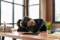 Exhausted, stressed asian young business woman working, took off eye strain glasses, rest nap, sleep on desk after work Royalty Free Stock Photo